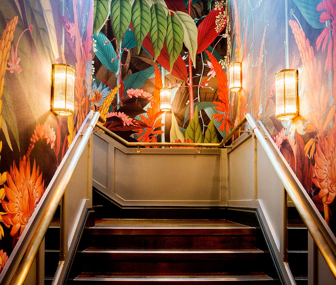 Exotic wallpaper wraps the stairs in Ivy Spinningfields
