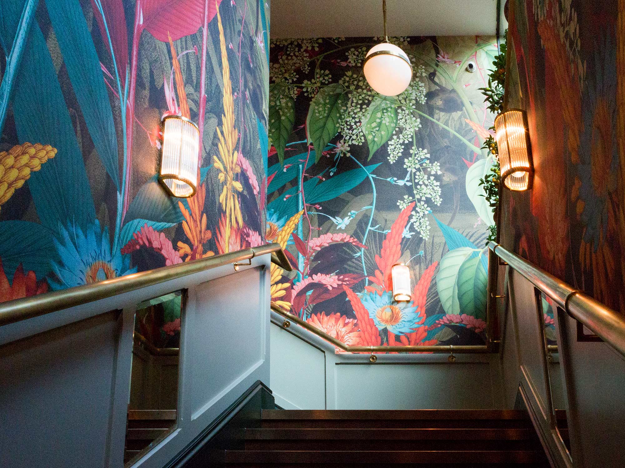 Hot tropics design above dado height wrapping a restaurant staircase