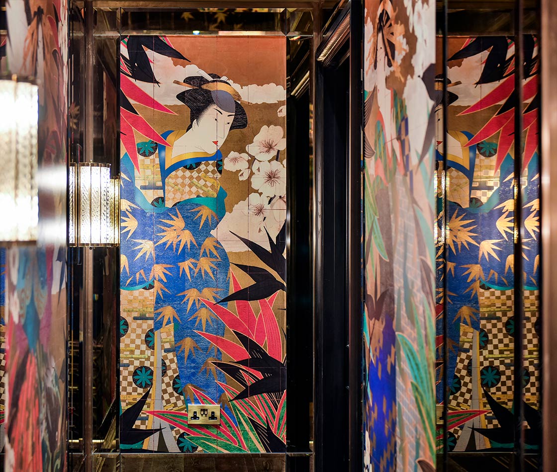 Gold leaf metallic wallpaper depicting elegant Geishas along the restaurant corridors