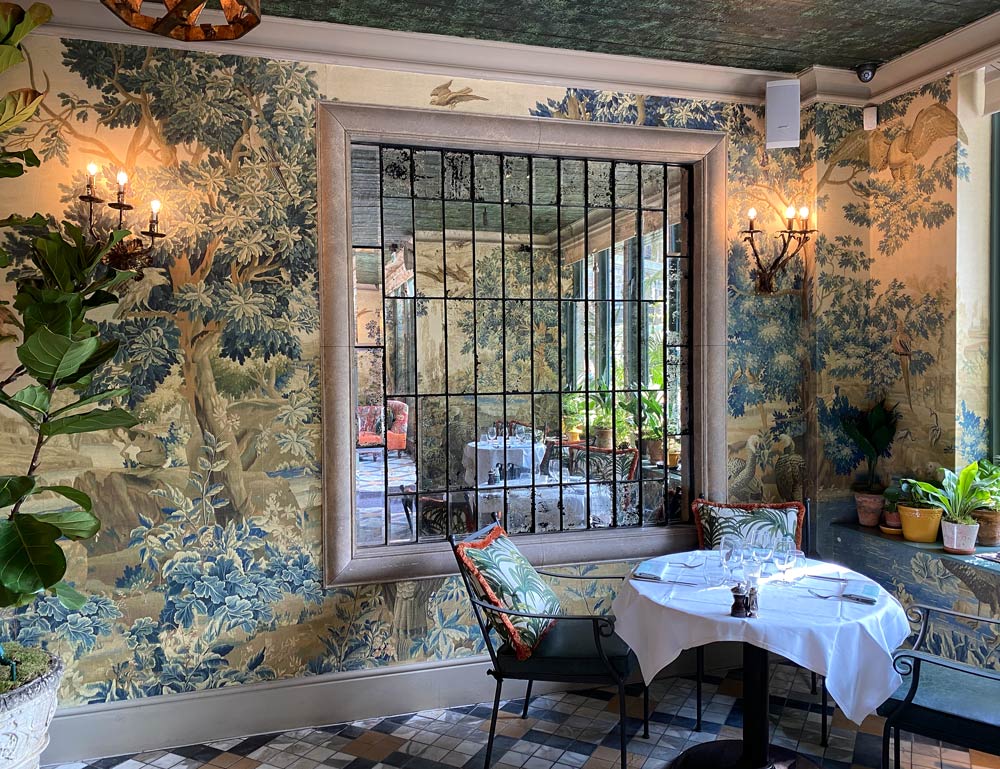 Jacquard tapestry reflected in restaurant mirrors