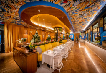 Issima restaurant ceiling in dining area featuring Adam Ellis 'Musa' wallpaper