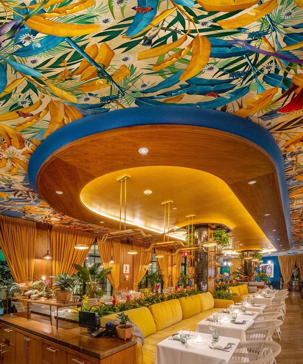 Issima restaurant ceiling wallpaper with palms and californian creates such as lizards and birds
